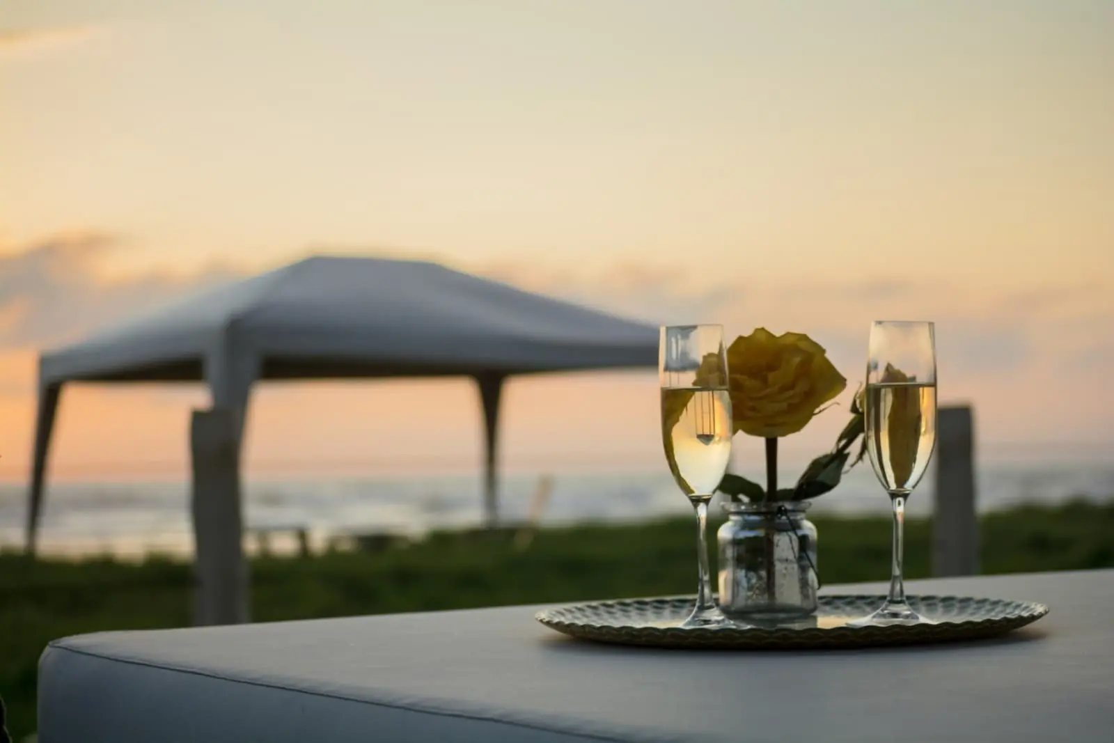 Champagne toast at a luxury beachside retreat at sunset