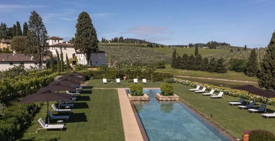 Historic Tuscan villa exterior surrounded by gardens